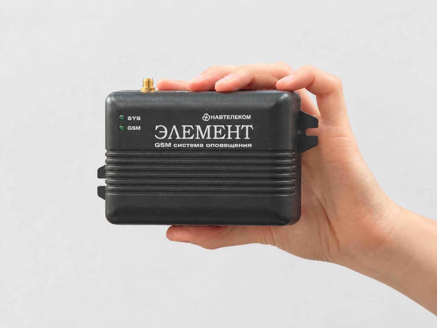 Dispositivo GSM de seguridad y notificación Navtelecom ELEMENT E-1120 sostenido en una mano