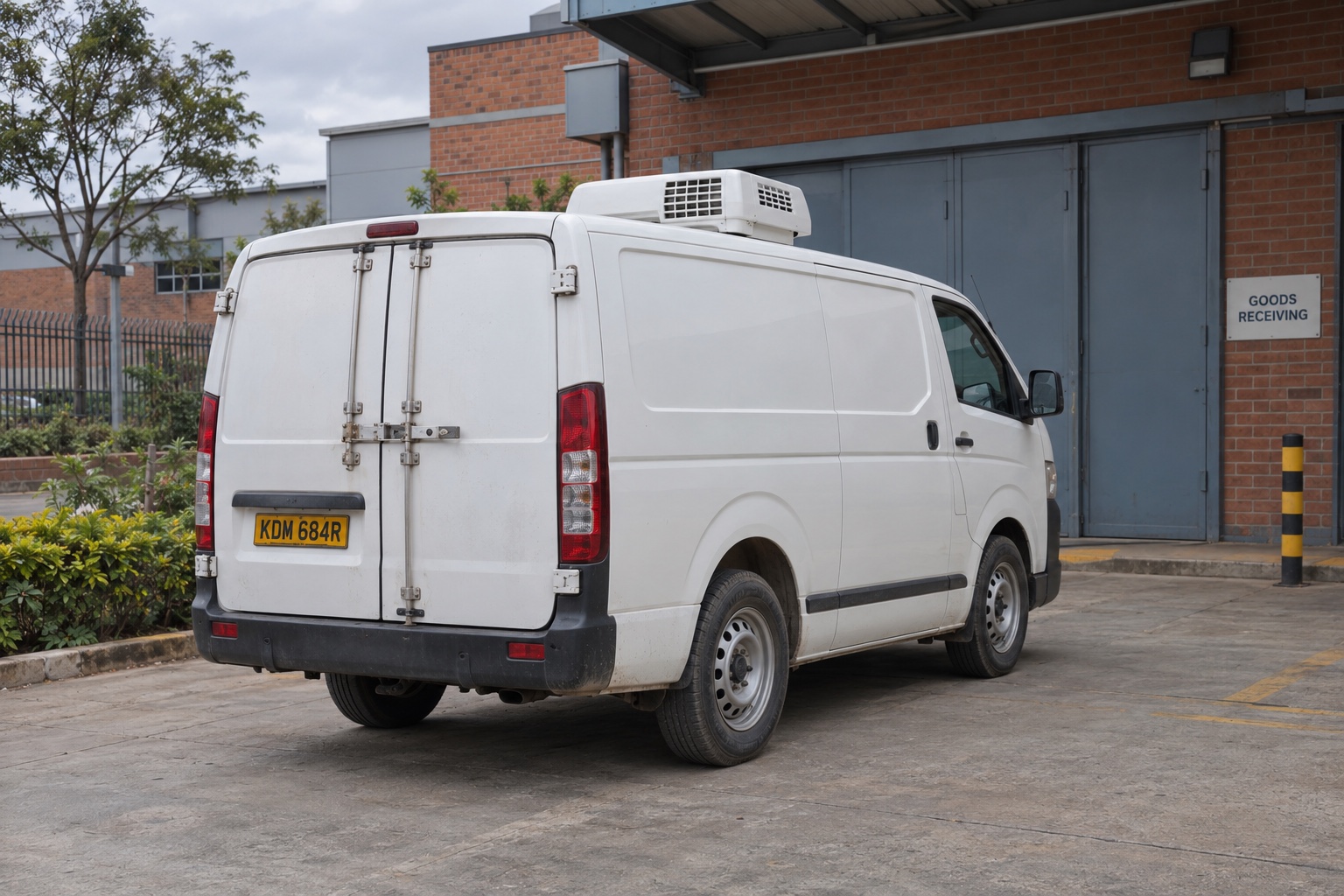 Refrigerated delivery van at a goods-receiving area in Nairobi, Kenya — illustrative scene