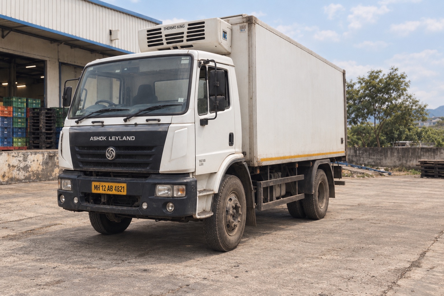 Ashok Leyland refrigerated food-delivery truck parked at a distribution yard in Maharashtra, India
