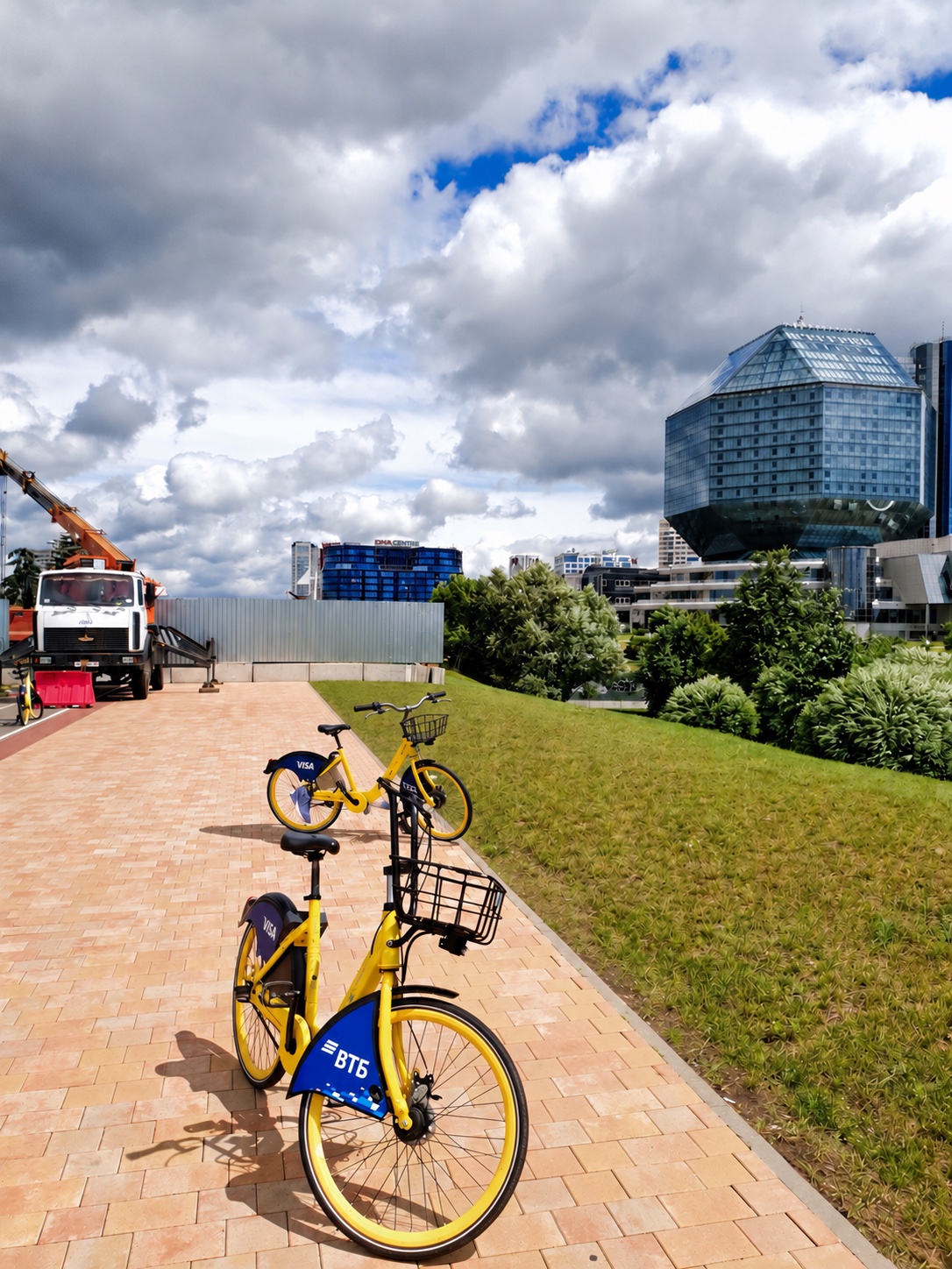 Yellow rental bicycles on a paved walkway in Minsk, Belarus
