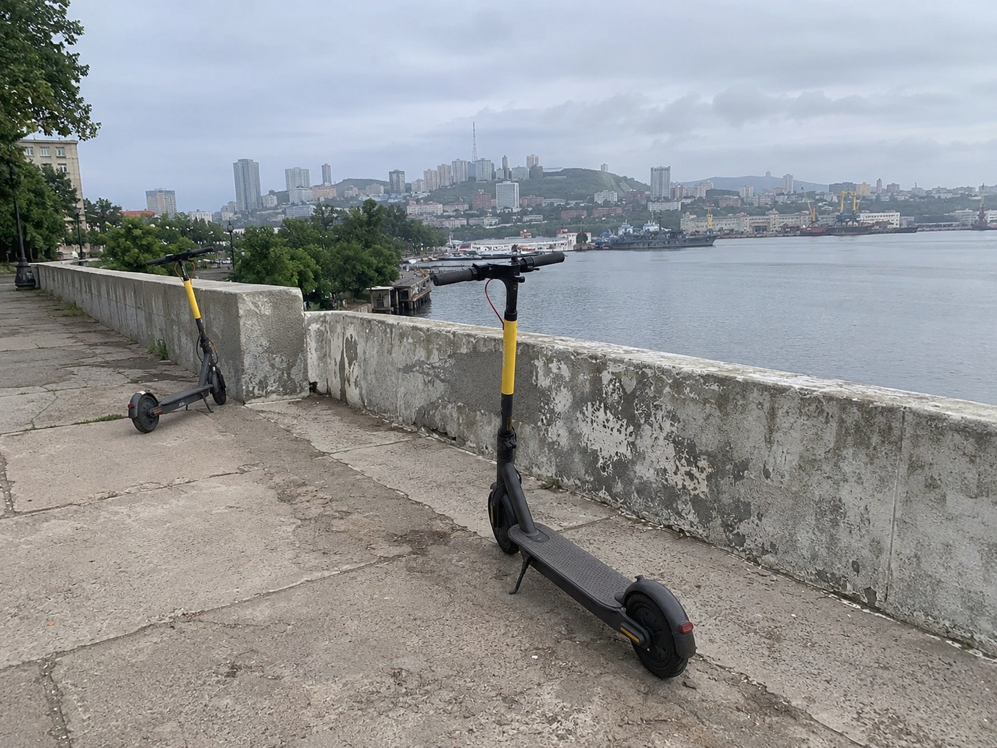 Rental electric scooters on a waterfront pavement in Vladivostok, Russia